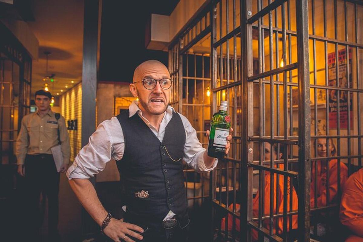 a man standing next to a cage with a bottle