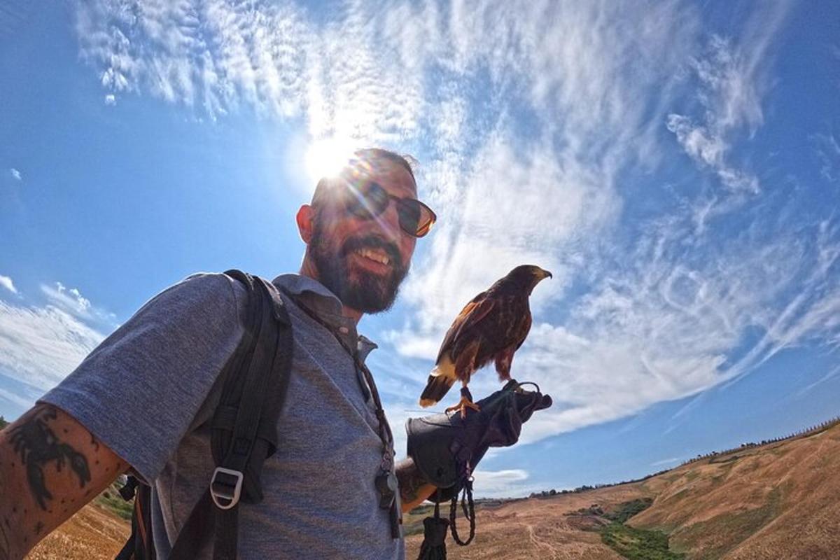 a man is holding a bird on a camera