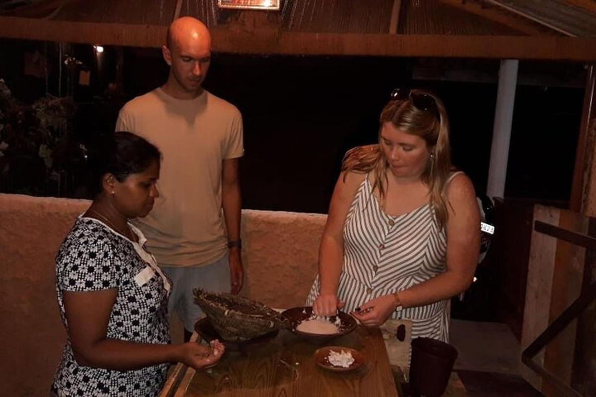 a group of people standing around a table with a cake