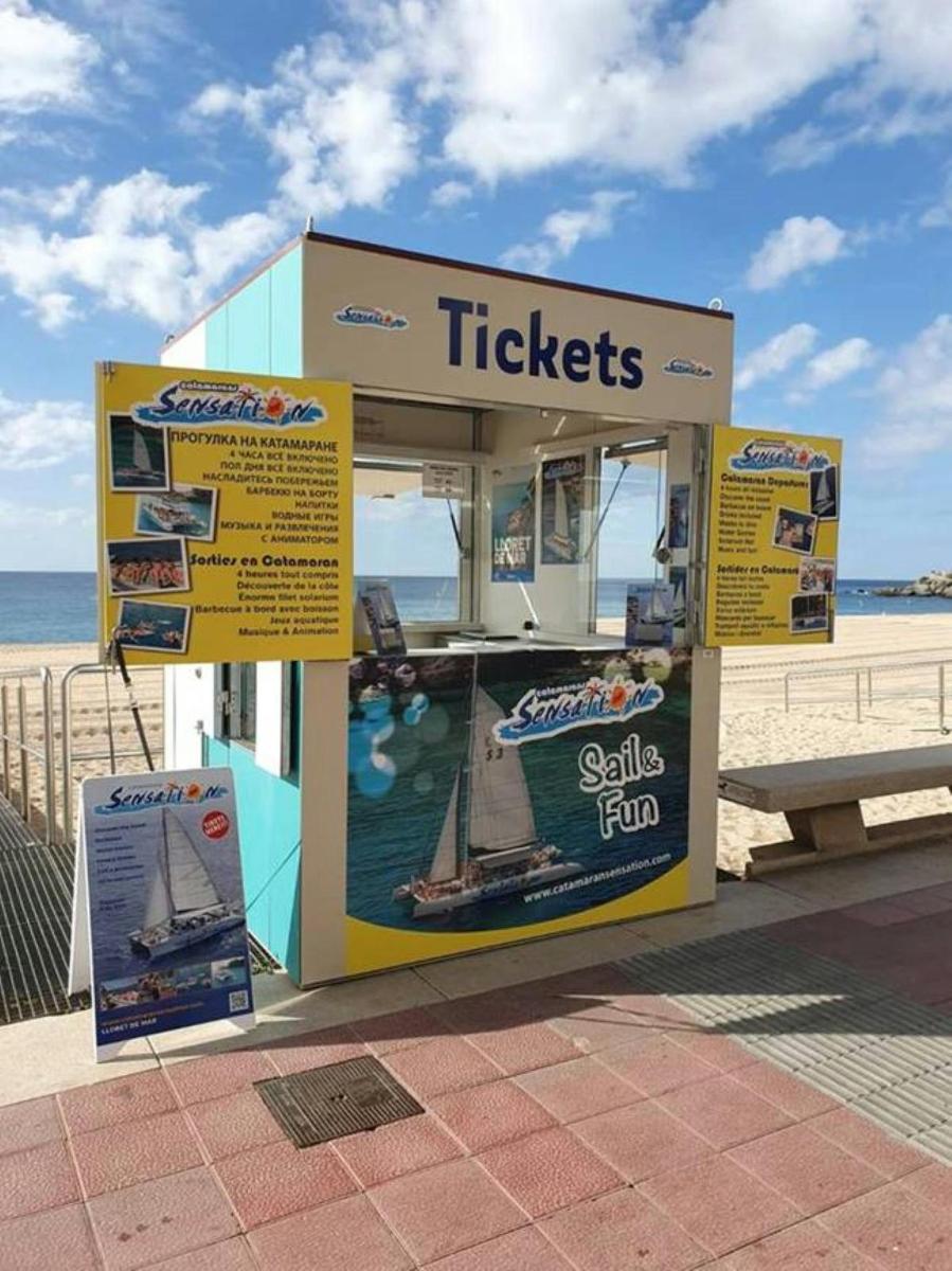 a kiosk on the beach next to the beach