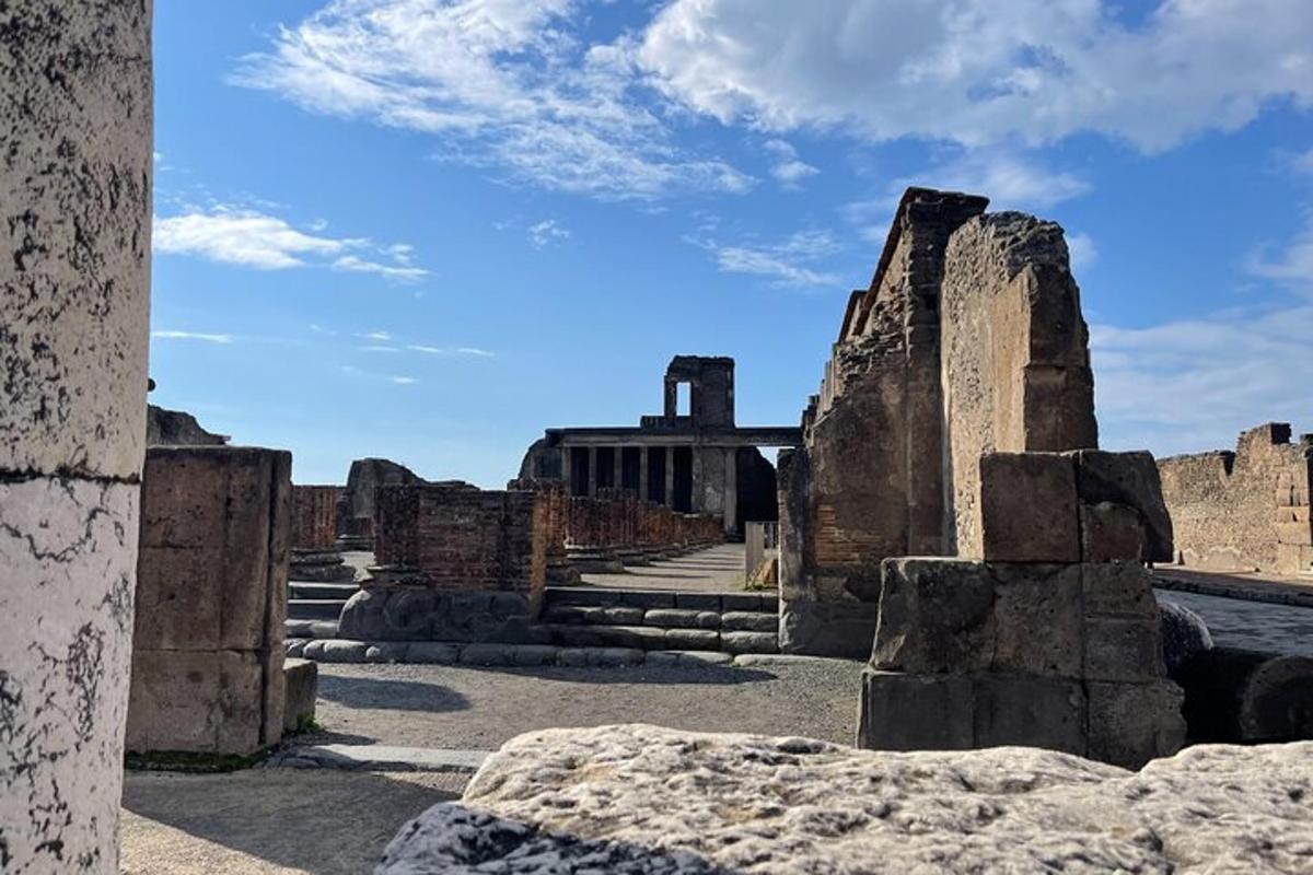 an ancient ruins with a building in the background