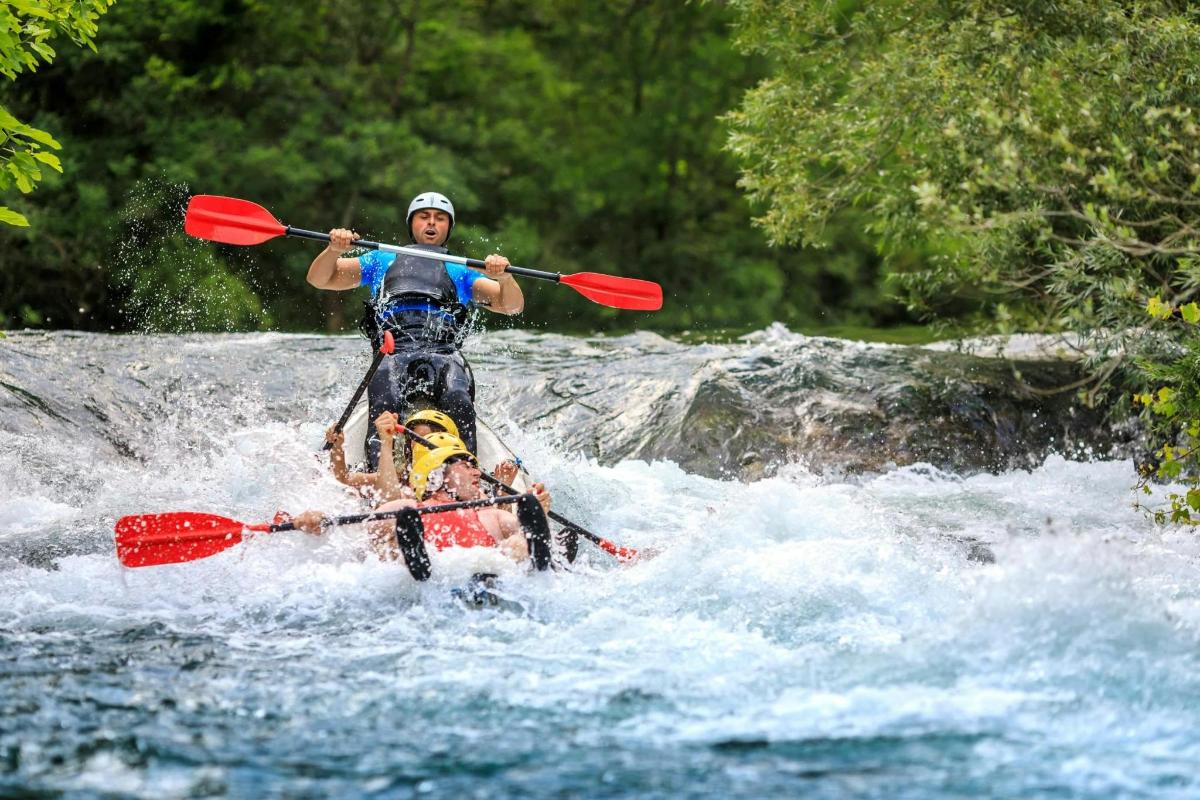 a man is on a raft in a river