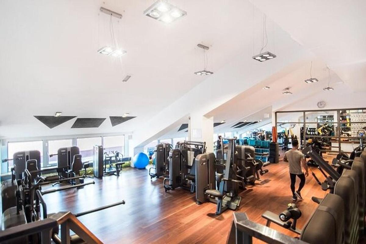 en mand går gennem et fitnesscenter med konditionsudstyr