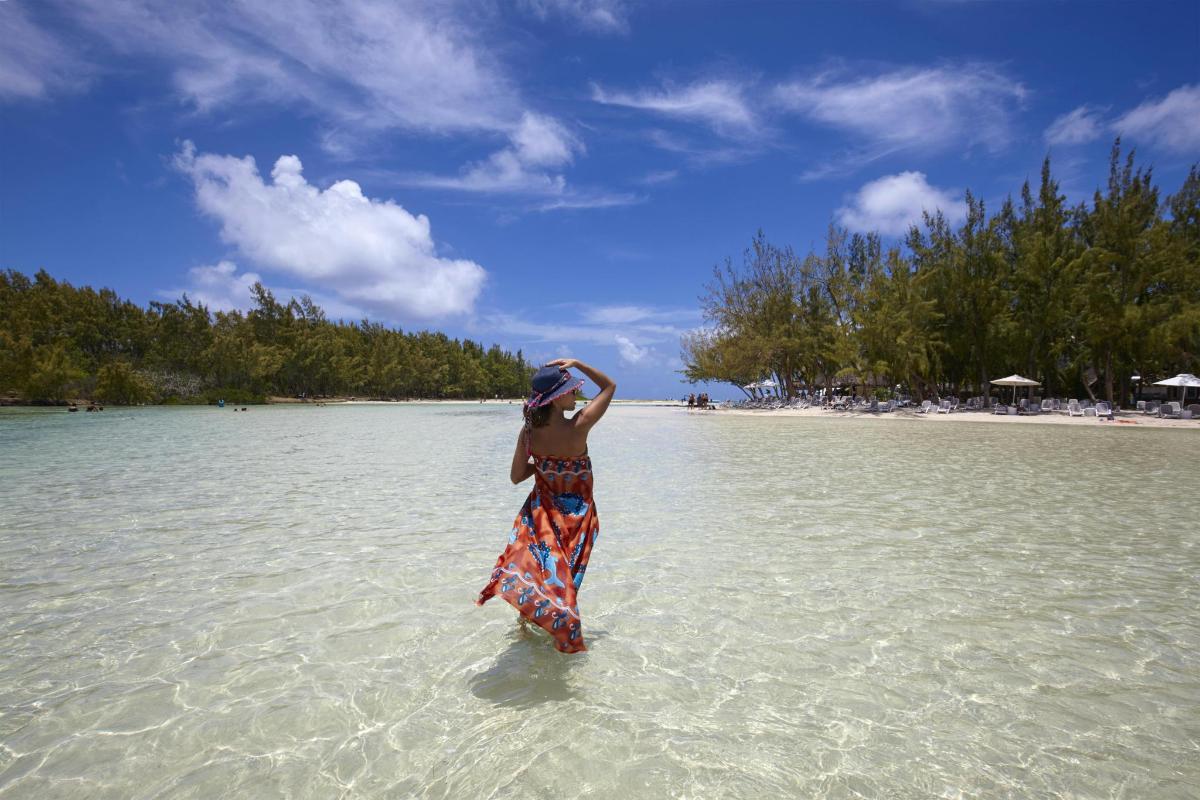 a woman standing in the water on a beach