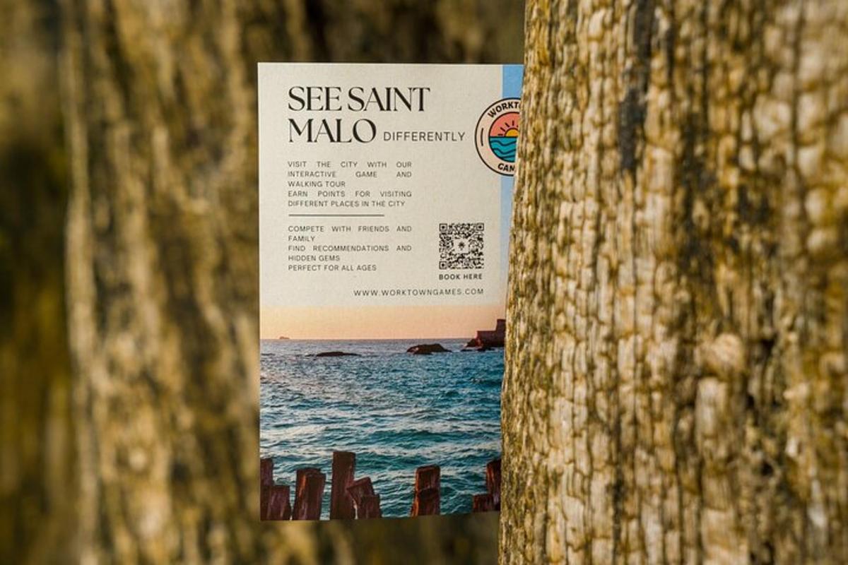 a sign on a tree with the ocean in the background