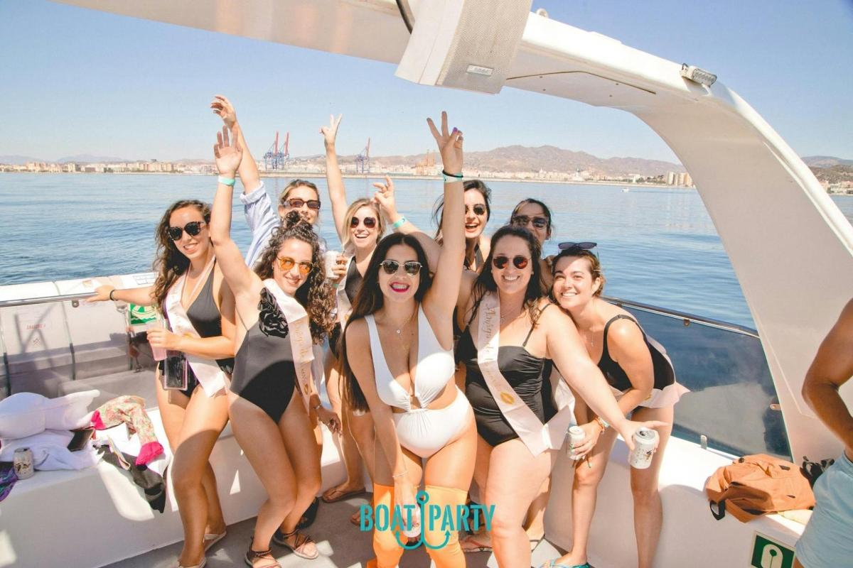 a group of people in bathing suits on a boat