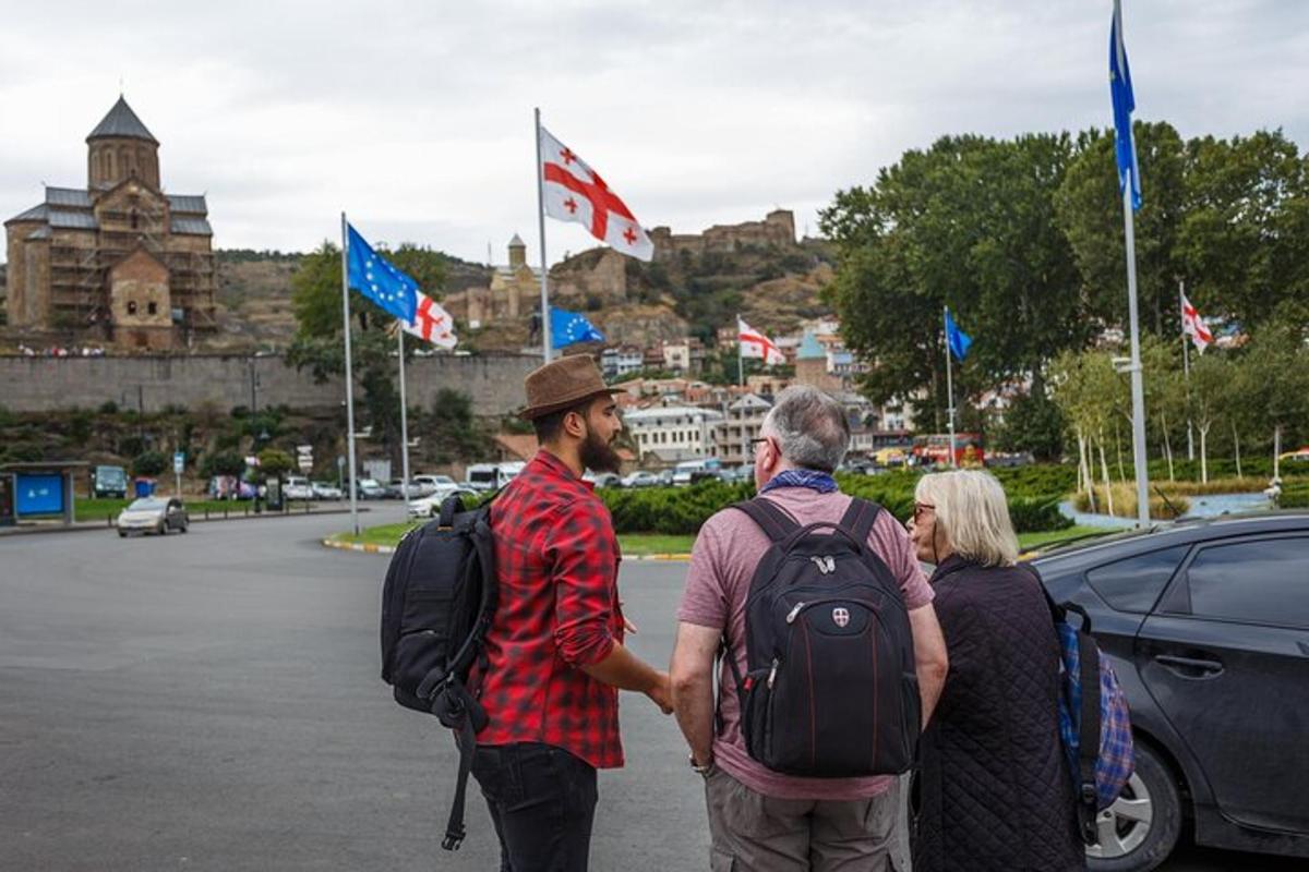 eine Gruppe von Menschen, die mit Fahnen eine Straße entlang gehen