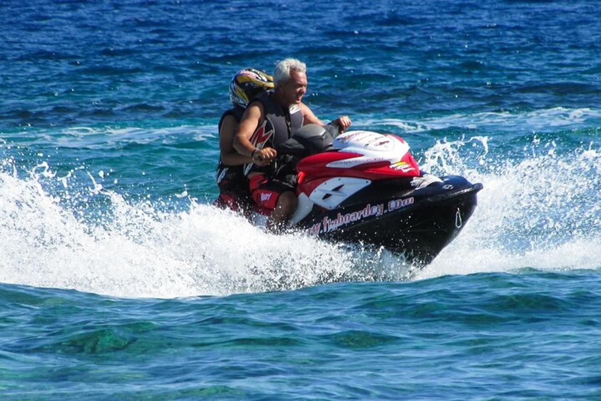Dos personas viajando en una moto acuática en el agua
