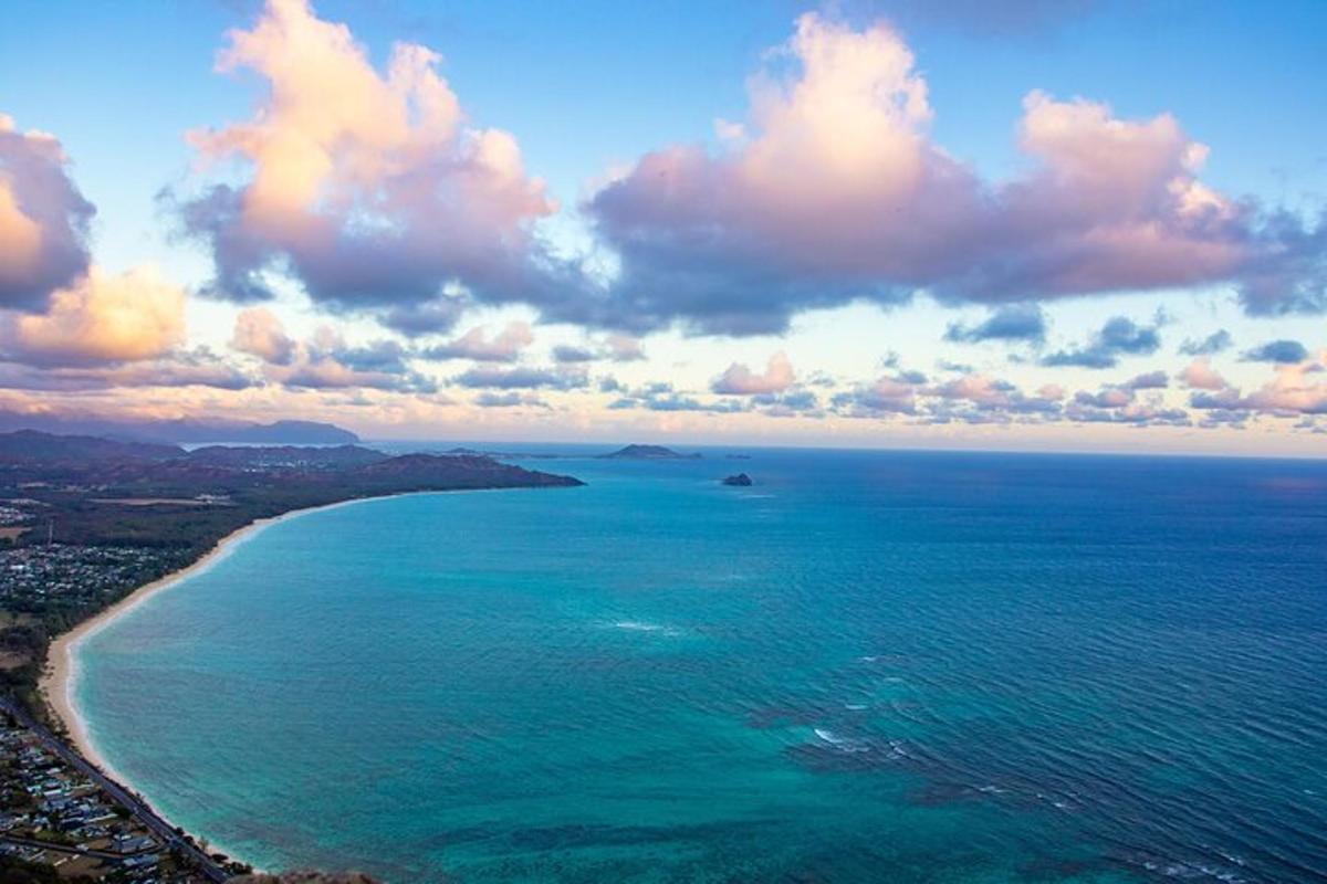 an aerial view of a beach with a boat in the water