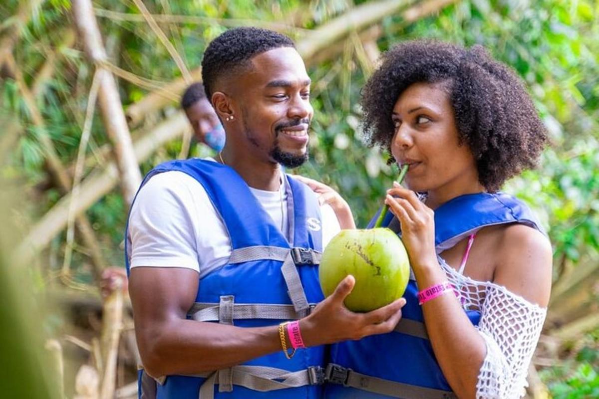 a man and a woman holding a green coconut