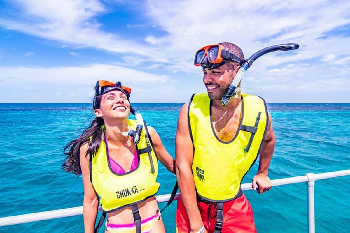 a man and woman in life jackets on a boat in the ocean