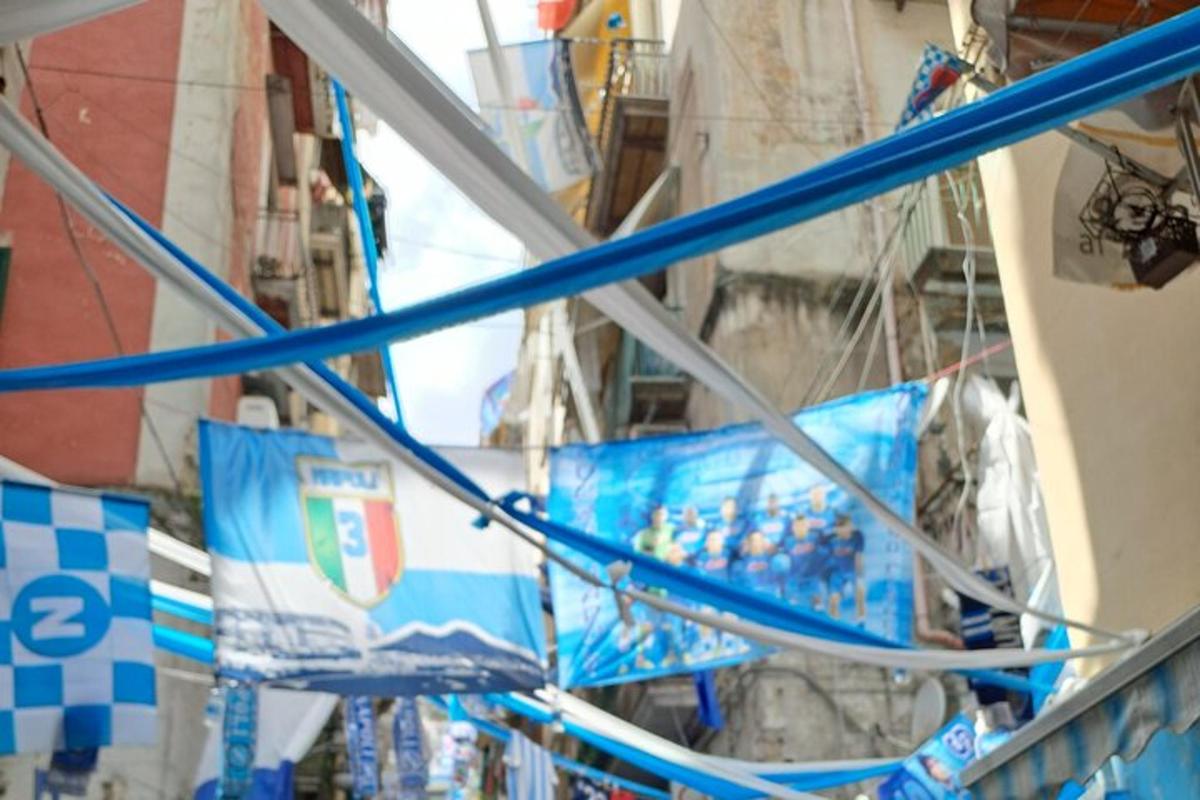 建物からぶら下がっている青い旗の群れ