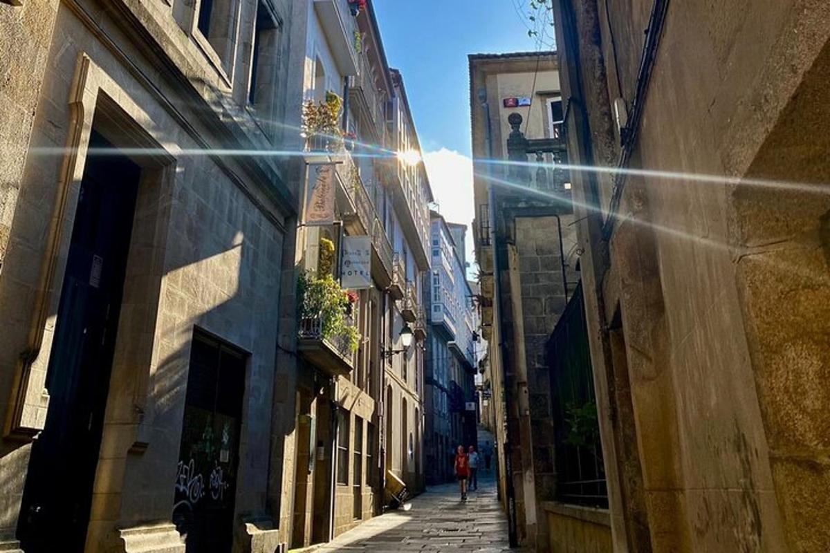 a person walking down an alley between two buildings