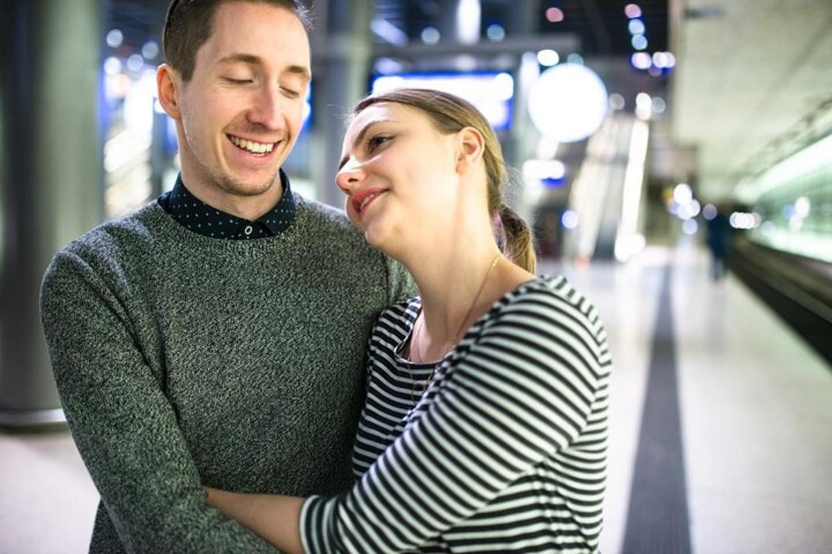 a man and a woman standing in a train station