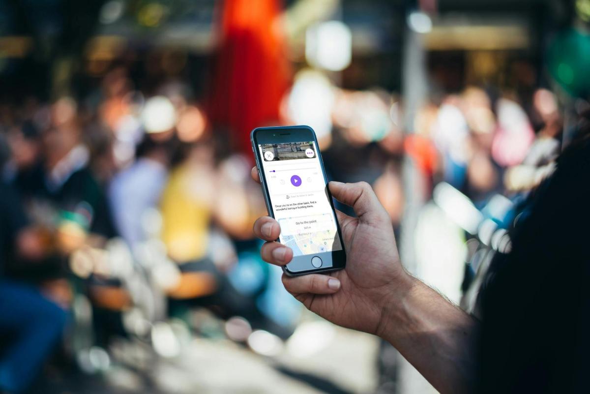 a person holding a cell phone in their hand