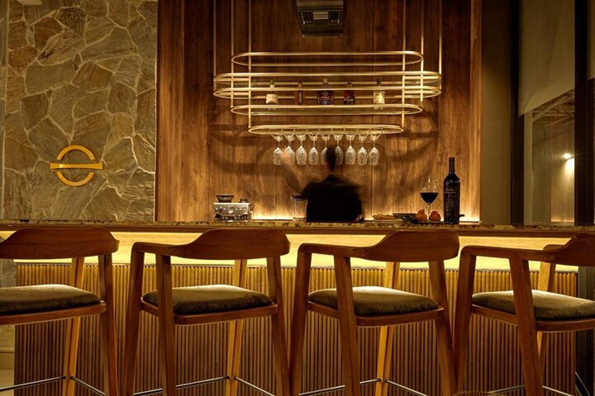 a bar with four stools at a counter in a kitchen