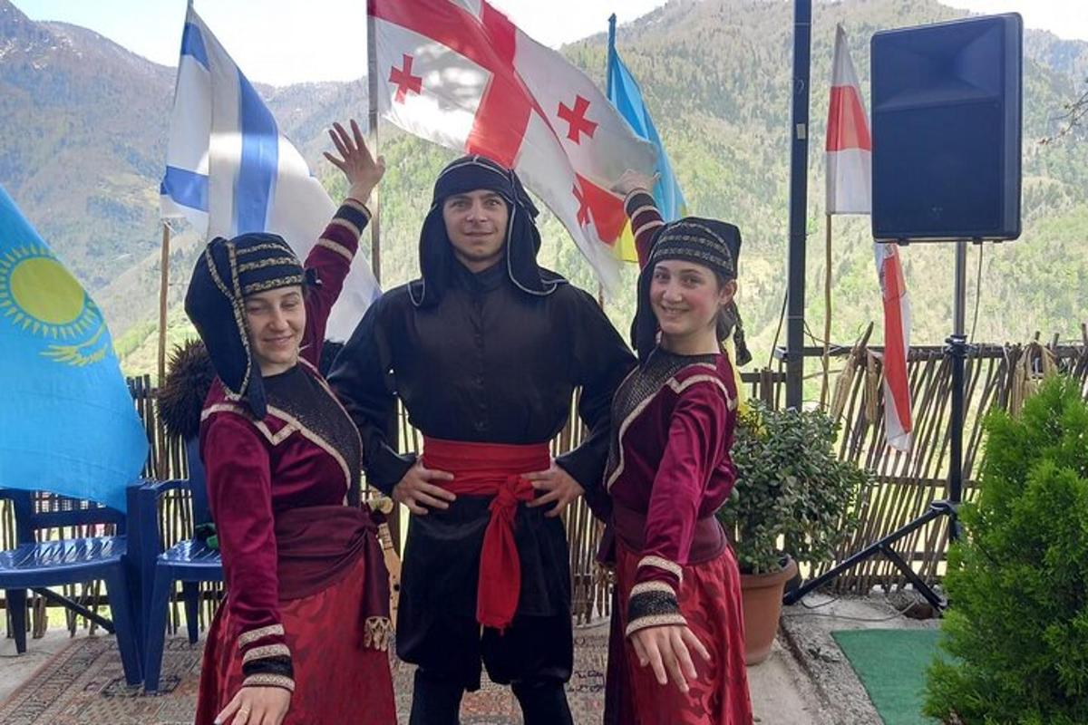 a man and two women standing in front of flags