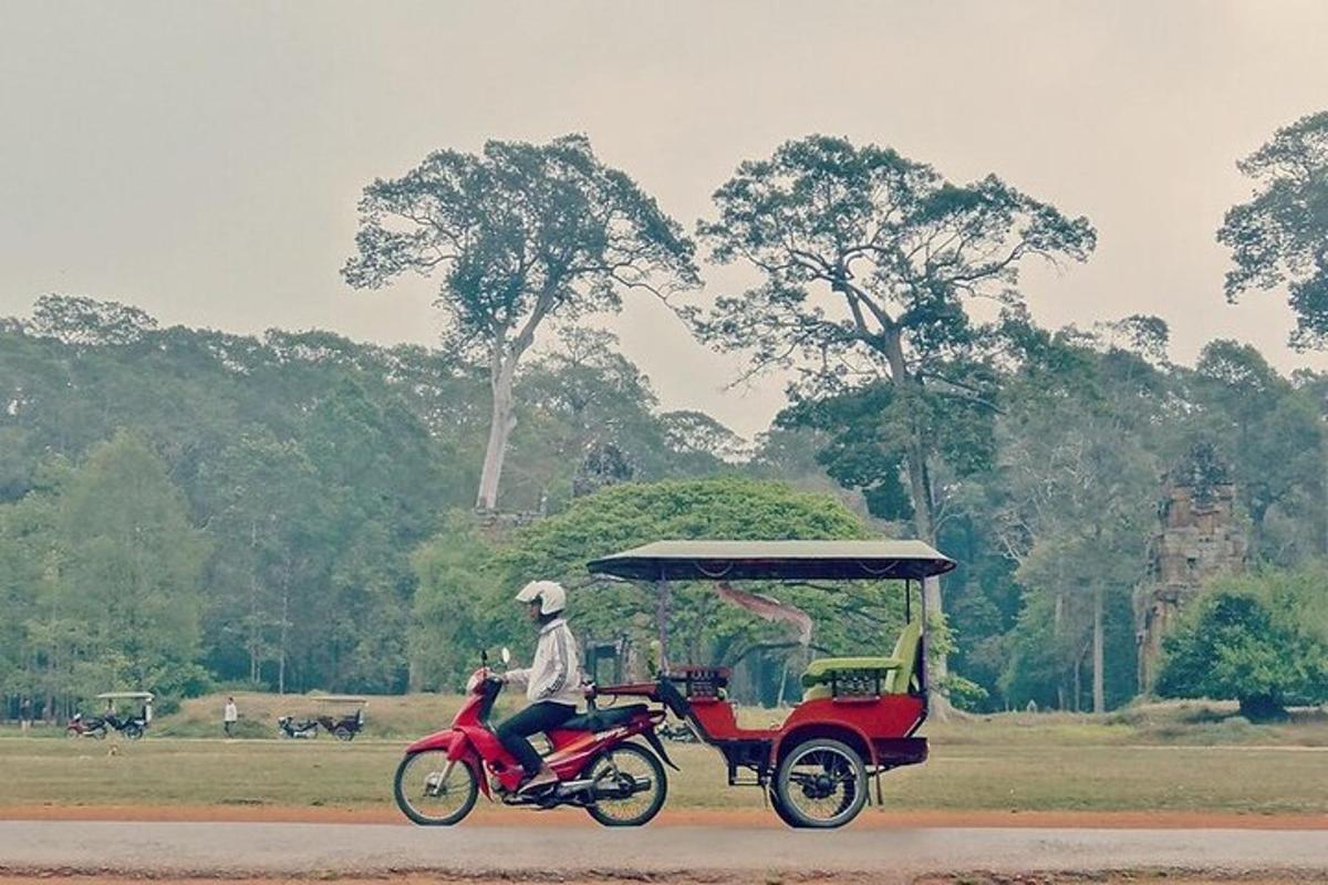 a person riding a red motorcycle with a cart