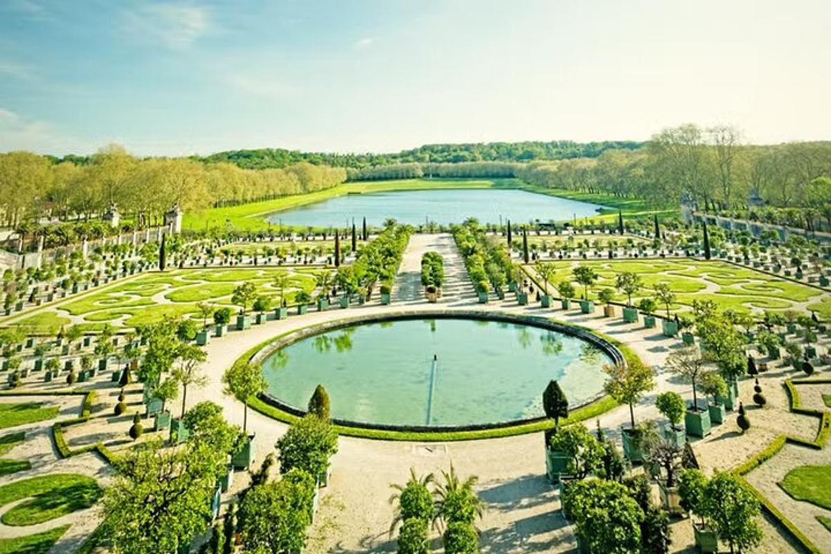 an aerial view of a garden with a pond