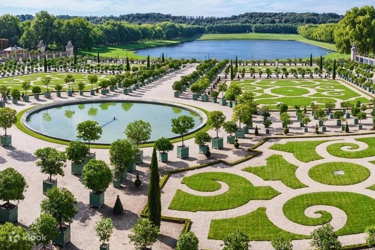an aerial view of a garden with a lake