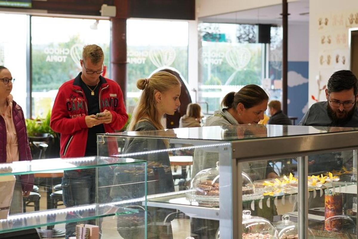 eine Gruppe von Menschen steht um eine Theke in einer Bäckerei