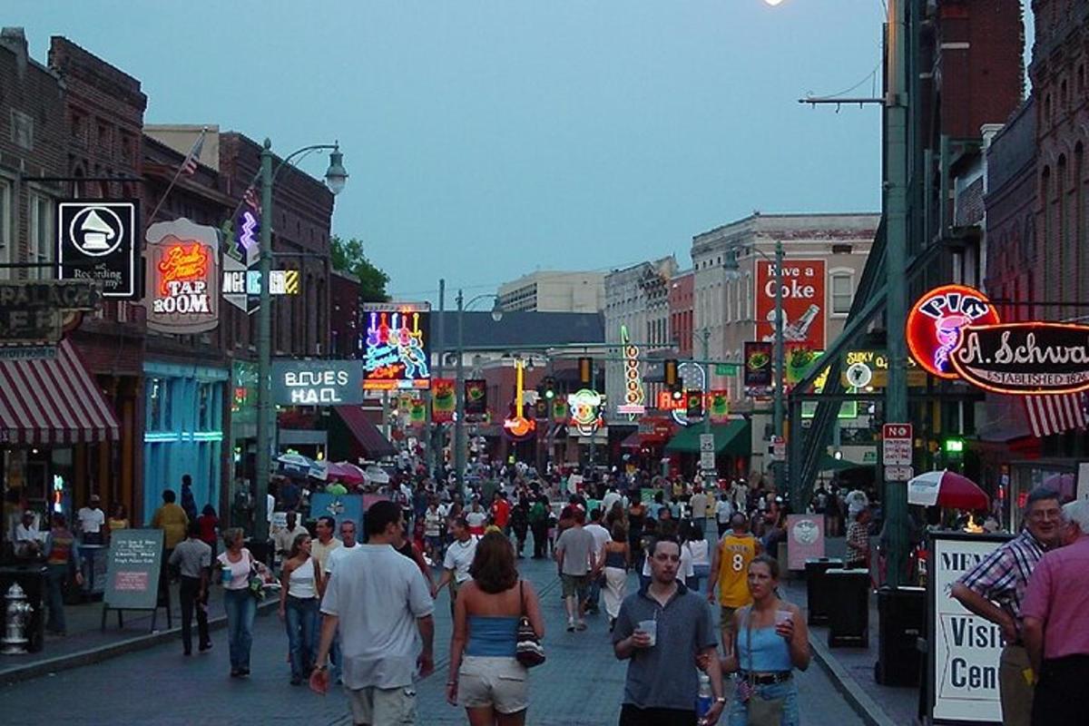a crowd of people walking down a busy city street