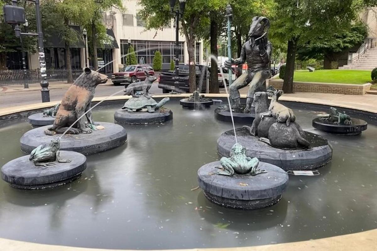 a fountain with statues of animals in the water