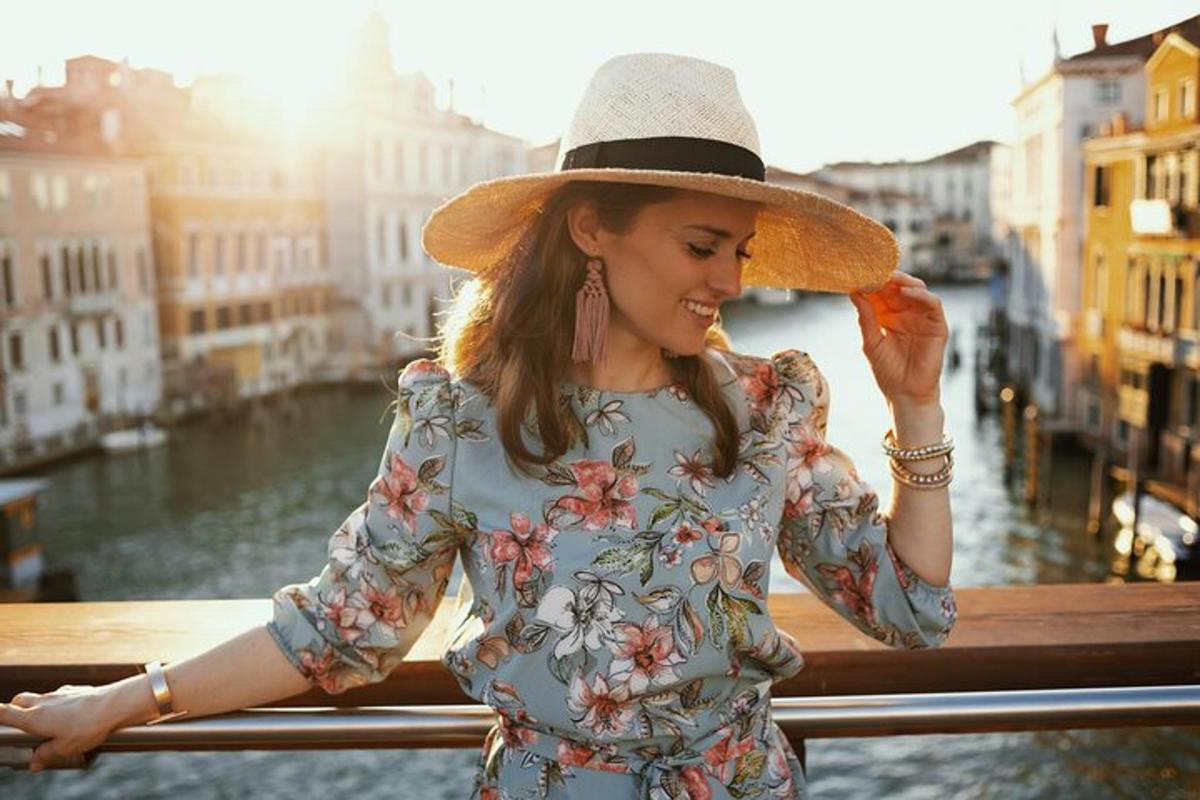 a woman wearing a hat standing on a bridge