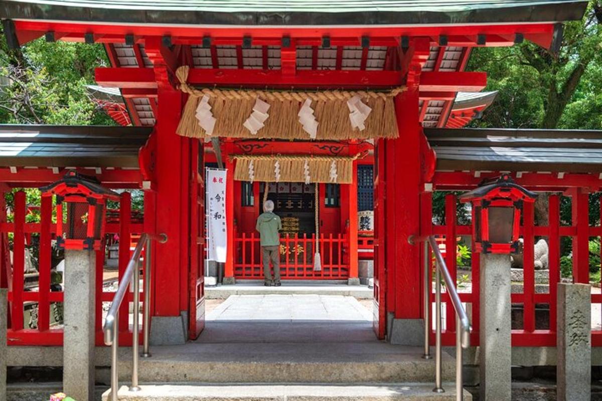 a man standing in the entrance to a red temple