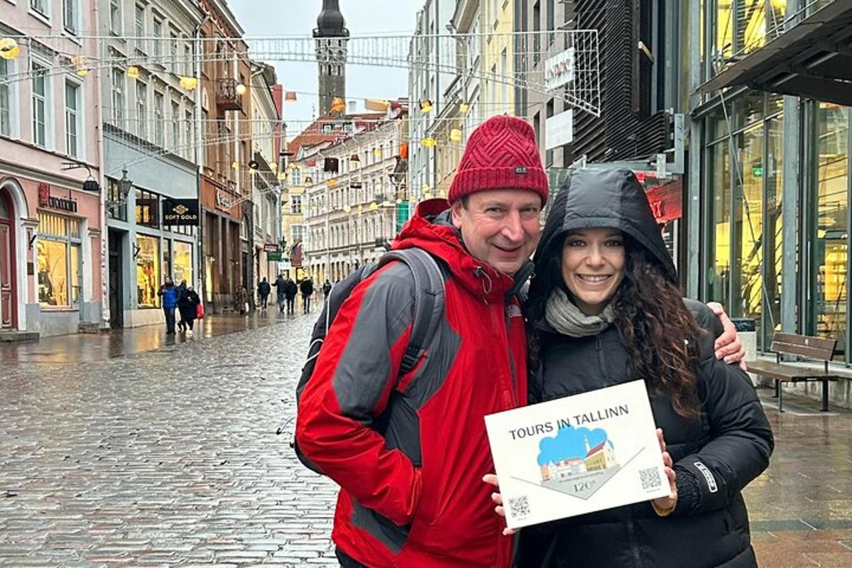 a man and a woman holding a sign on a street