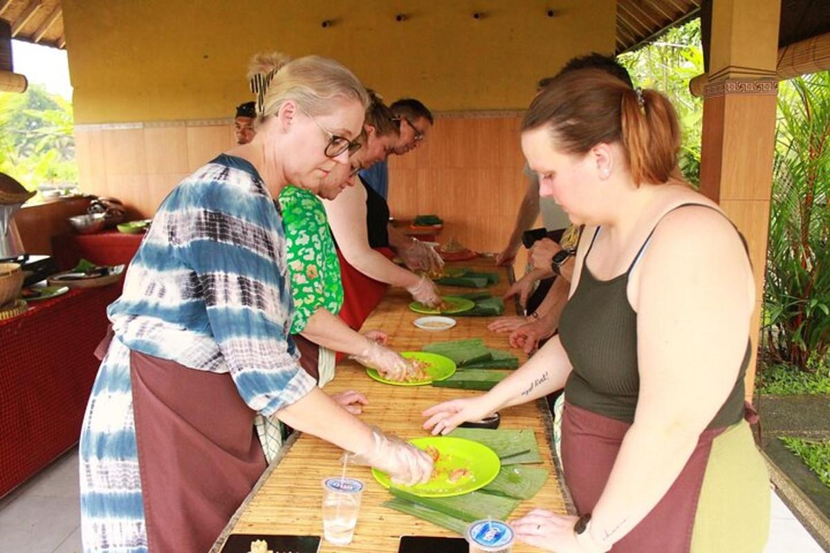 a group of people standing around a table preparing food