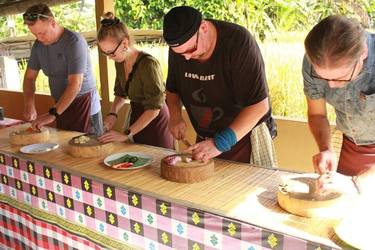 a group of people standing around a table cutting cakes