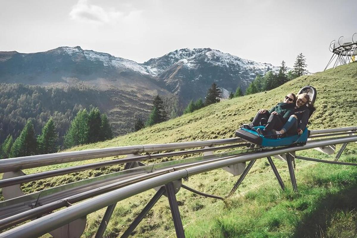 two people are riding on a sled on a mountain