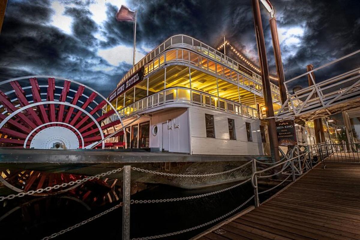 a boat on a pier with a roller coaster