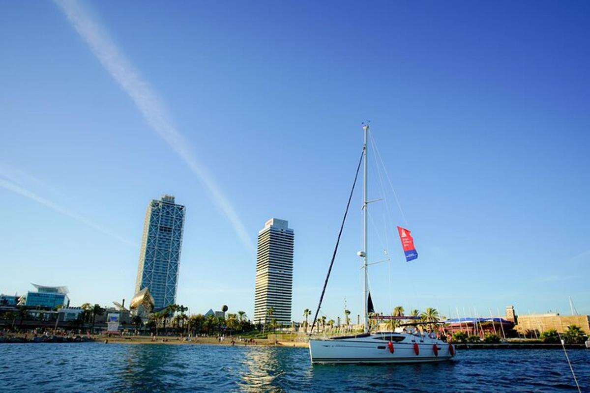 a sailboat in the water in front of a city