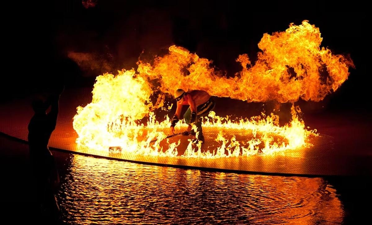 a person is standing on fire in the water