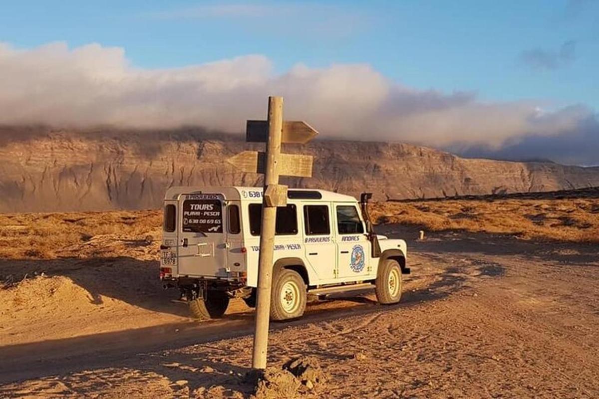 a white truck on a dirt road in the desert