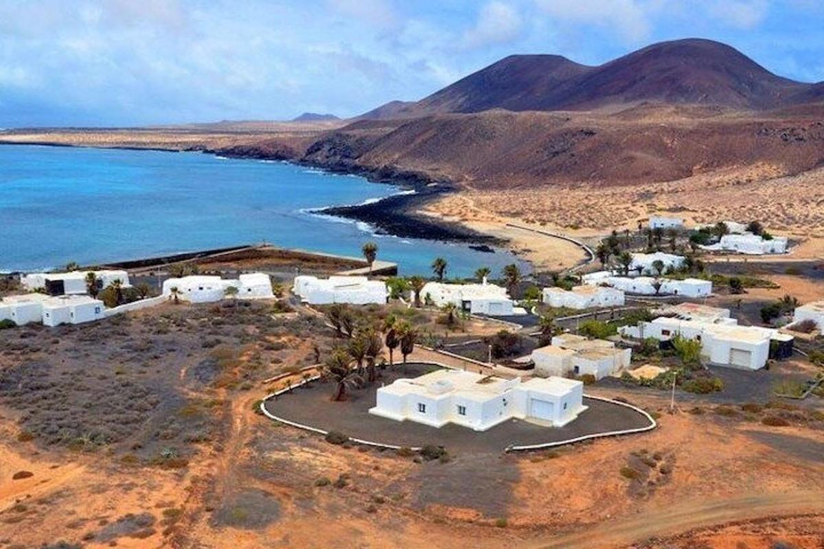 an island with white buildings and the ocean