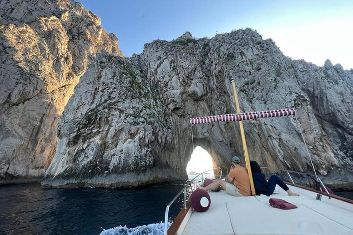 a man and woman sitting on a boat in front of a mountain