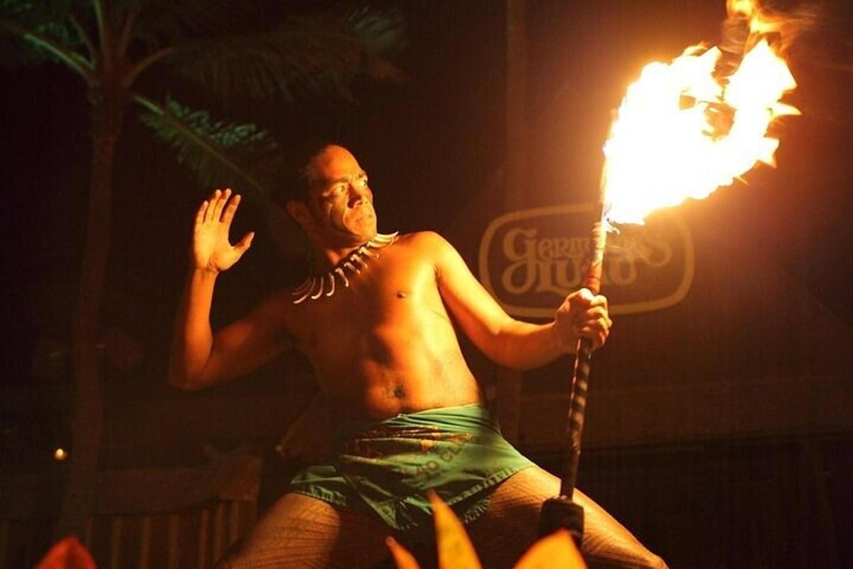 a shirtless man holding a flaming torch
