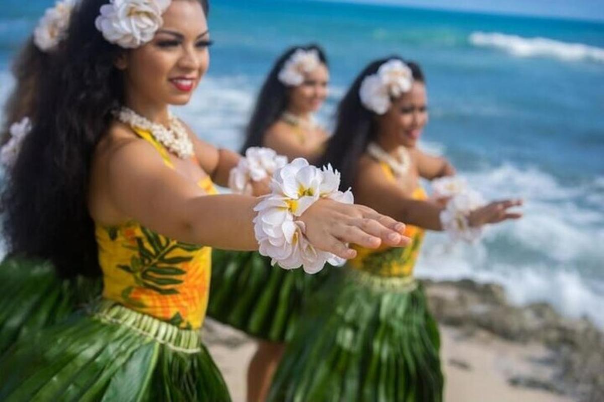 a group of women dancing on the beach