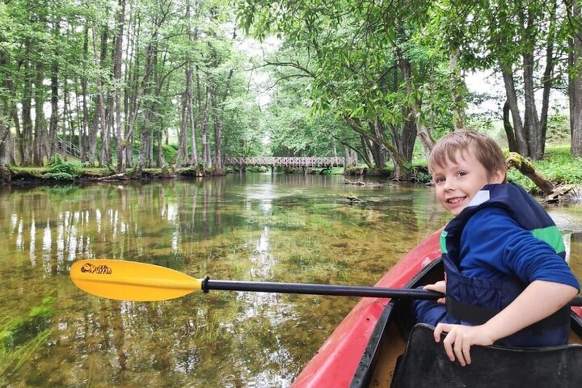 a young boy in a canoe on a river