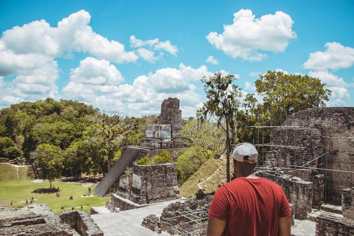 a man standing at the ruins of a temple
