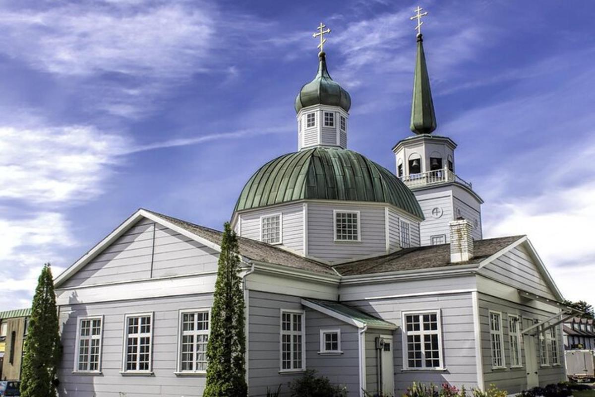 a large white church with a green domed roof
