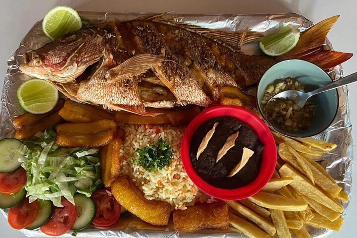 a plate of food with fish and rice and fries