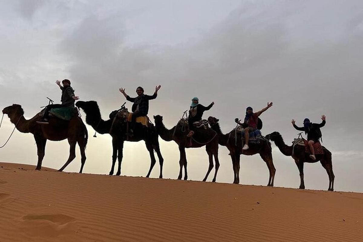 a group of people riding on horses in the desert