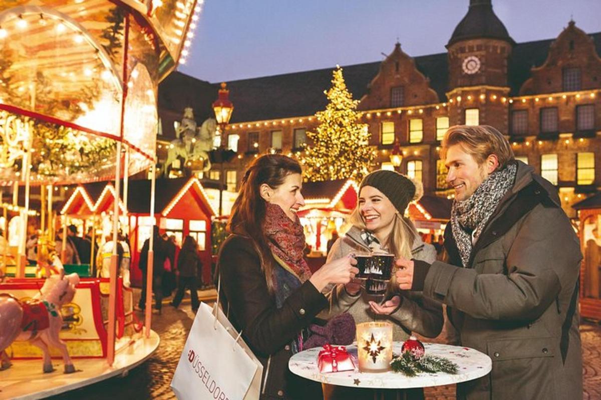 a group of people taking a picture of a christmas market