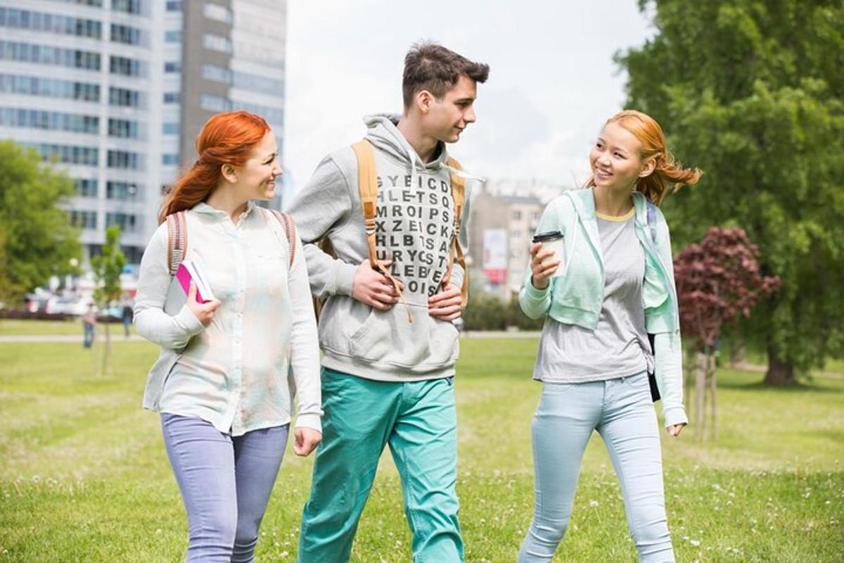 a group of three people walking in a park