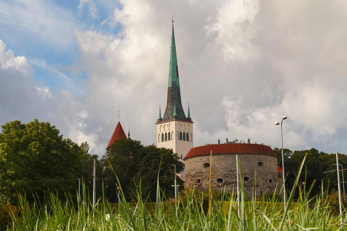 a church with a steeple in the middle of a field