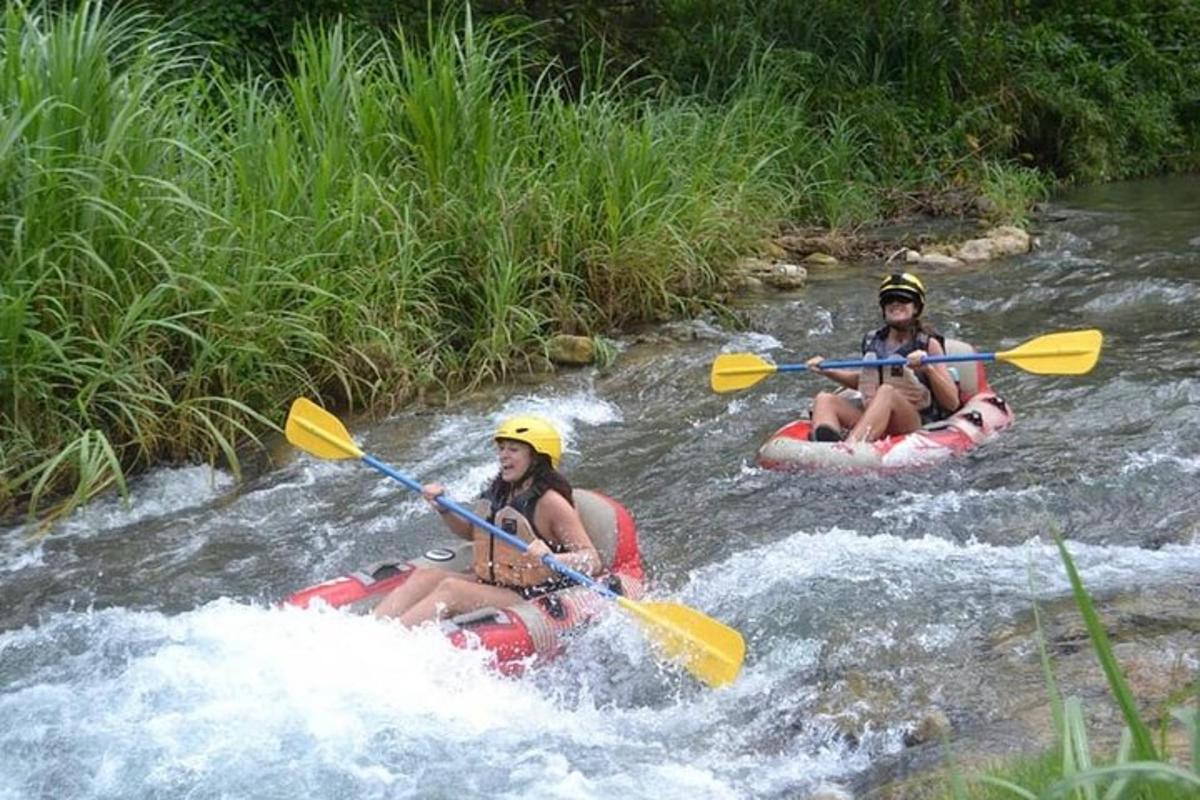 two people in kayaks on a river in the water